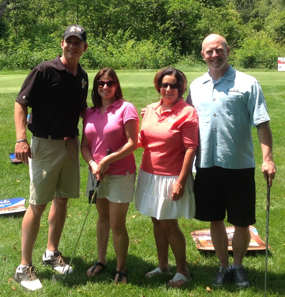 Pictured at the fourth hole of Ledgemont Country Club in Seekonk, MA. are, from left: Jeff Wells, President and Founder of WISH for OUR HEROES; Kim Paderson, Smiles & Miles Travel’s Sales and Marketing Associate; Ellen Paderson, Founder/Owner of Smiles & Miles; and Kirk Olsen, Regional Business Development Manager for Sandals / Beaches Resorts.
